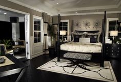 a bedroom with black and white decor in it