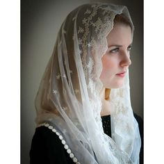 a woman wearing a white veil and black dress