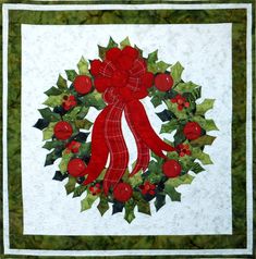 a holly wreath quilt design with appliqued holly leaves and berries. Wreath includes a large tartan ribbon at the top. The quilt is finished with two borders and binding. Wreath Quilt, Quilted Table Runners Christmas, Table Topper Patterns, Holly Wreath, Applique Quilt Patterns, Applique Quilting, Winter Quilts, Holiday Patterns, Quilting For Beginners