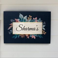 a sign that says sharna's on it with flowers and leaves around it