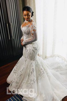 a woman in a wedding dress posing for the camera