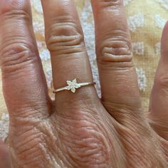 a close up of a person's hand with a ring on it