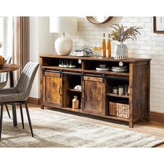 a dining room table with two chairs and a large wooden cabinet in front of it