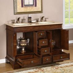 a bathroom vanity with two sinks and drawers