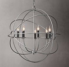 an orb chandelier with five candles hanging from it