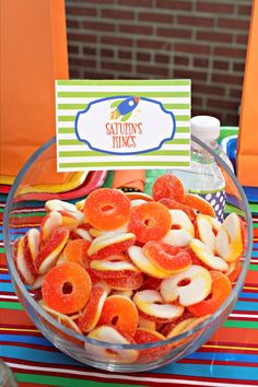 a bowl filled with fruit sitting on top of a table