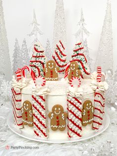 a decorated christmas cake with gingerbreads and candy canes