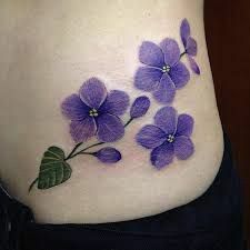 a woman's stomach with purple flowers on it