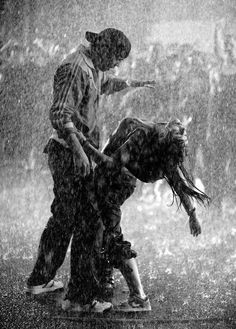 two people standing in the rain with one person touching another's head and texting don't give up, just be you cause life is too short like anyone else