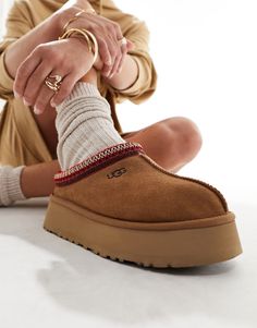 Slippers by UGG Good things come in pairs Pull tab for easy entry Braided cuff Signature UGG branding Round toe Platform sole Ugg Tazz Platform, Cute Uggs, Ugg Tazz, Ugg Tasman, Tie Maxi Dress, Platform Mules, Women's Spurs, Platform Slippers, Womens Loungewear