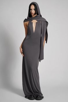 Make them take a second glance. Maxi dress made from luxuriously dense Jersey, featuring an add-on hood that can be draped across the shoulders and over the crown of the head, with plunging halter top neckline. FIT NOTES:Tatianna wears a size Small, 5'9, with a 26" waist.MATERIALS:95% rayon 5% spandexMade in China Glamour Spell, Spy Outfit, Dress With Hood, Dystopian Fashion, Top Neckline, Steel Grey, Color Khaki, Black Media, The Crown