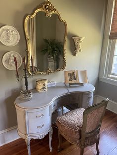 a white desk with a mirror and chair