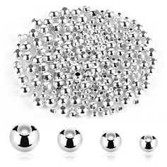 chrome steel balls and screws are arranged in the shape of a circle on a white background