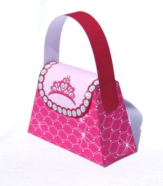 a pink paper bag with a tiara on it