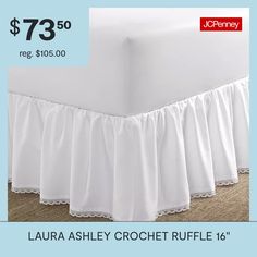 a bed with white ruffled bedskirt and price tag for $ 79 50