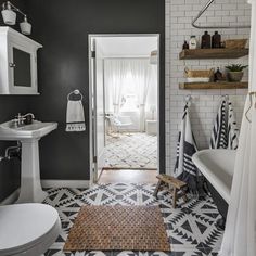 a bathroom with black walls and white fixtures