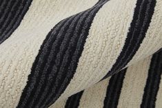 black and white striped fabric close up on the back of a couch cushion, with vertical stripes