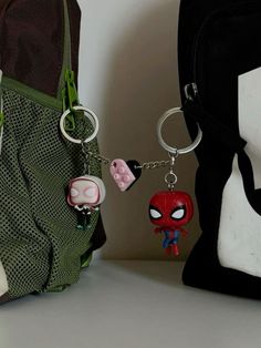 the spiderman keychain is next to a bag