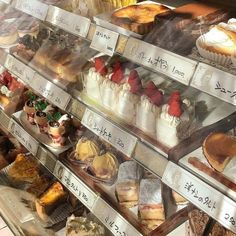 a display case filled with lots of different types of cakes