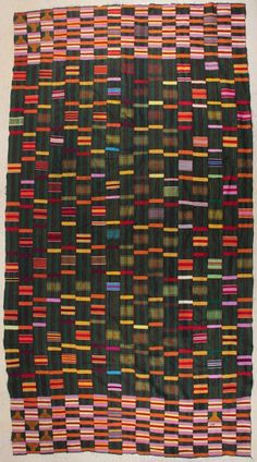 a multicolored piece of cloth is displayed on a white surface with black, red, green, and yellow stripes