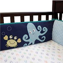 a crib bed with an octopus and crab appliqued on the side