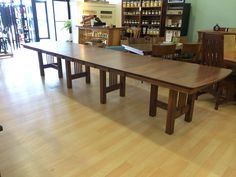 a large wooden table sitting in the middle of a room