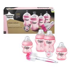 the baby bottles and brush are pink in color