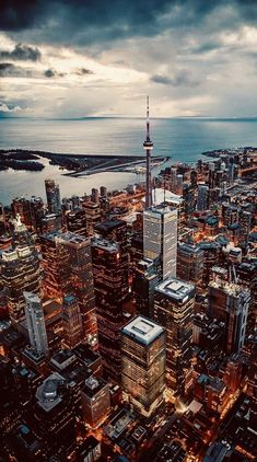 an aerial view of the city lights and skyscrapers at night in toronto, canada