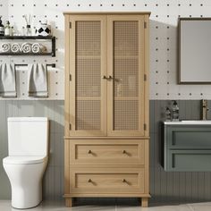 a wooden cabinet next to a toilet in a bathroom