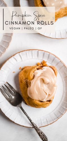 two plates with cinnamon rolls on them and a fork next to one that has icing on it