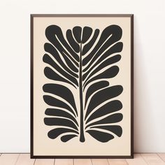 a black and white poster with a large leaf on it's left hand side