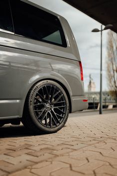 a silver van parked in front of a building