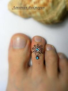 a person's toe with a ring on it