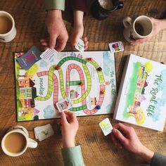 two people playing a board game on a table with cups of coffee and paper napkins