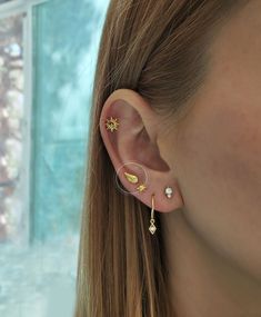 a close up of a person wearing ear piercings