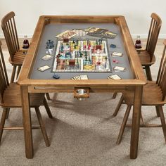 a wooden table topped with lots of cards and dices on top of carpeted flooring