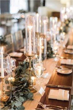 a long table with candles and place settings