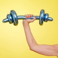 a woman holding a barbell over her shoulder