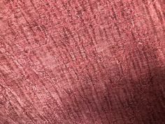 an old red cloth textured with small stitches and lines, as well as the background