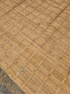 a brown rug with fringes on top of it