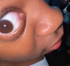 a close up of a person's face with an eyeball on their nose