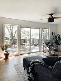 a living room filled with furniture and large sliding glass doors that open onto a deck