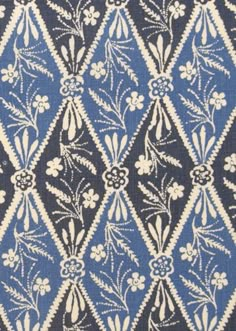 a blue and white pattern with flowers on it