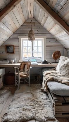 an attic bedroom with wooden walls and flooring is decorated in natural wood planks