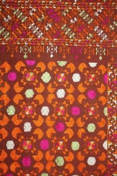 an orange, pink and green patterned cloth