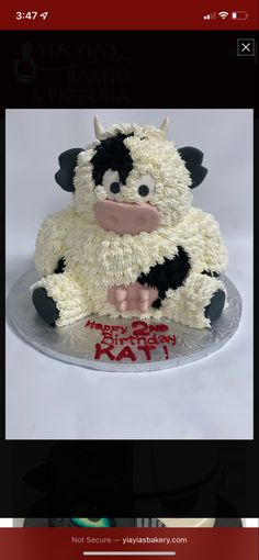 a cake that looks like a cow sitting on top of a table