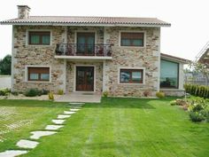 a stone house with steps leading to the front door