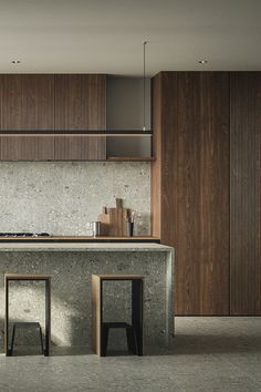 two stools sit in front of an island counter with wooden paneling on the wall