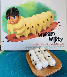 there is a wooden plate with some food on it next to a sign that says william and the giant banana