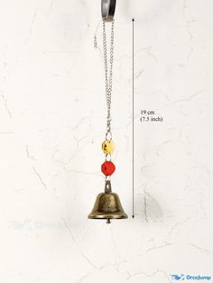 a bell with two bells attached to it's side on a white marble wall